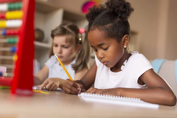 Two Little Girls Sitting Desk Writing Notebooks Doing Math Homework — Stock Photo, Image