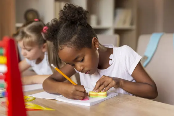 Two Little Girls Sitting Desk Writing Notebooks Doing Math Homework — Stock Photo, Image