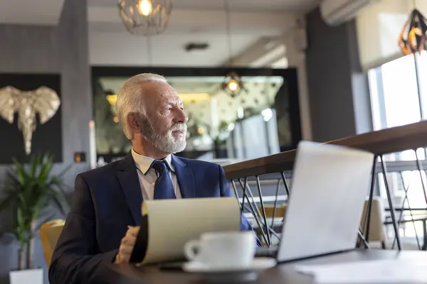 Senior Geschäftsmann Sitzt Einem Restauranttisch Arbeitet Laptop Analysiert Und Unterschreibt — Stockfoto
