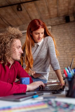 Ortak çalışma alanında çalışan serbest bilişim uzmanları; modern ofiste çalışan genç iş adamları