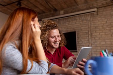 Yazılım geliştirme şirketinde yeni bir proje üzerinde çalışan iki yazılım geliştiricisi; modern ortak çalışma alanında çalışan serbest çalışanlar