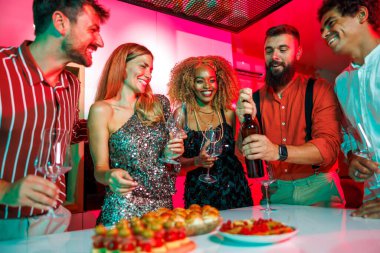 Bir grup neşeli arkadaş bir ev partisinde eğleniyor. Arkadaşlarının doğum gününü kutlarken bir şişe şarap açıyorlar.