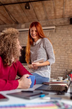 Ortak çalışma alanında çalışan serbest programcılar; modern ofiste çalışan genç iş adamları