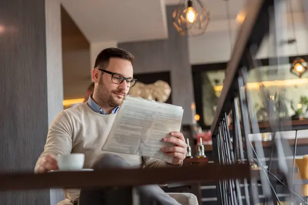 Portrait Pensive Man Sitting Restaurant Table Reading Newspaper Drinking Coffee — Stock Photo, Image