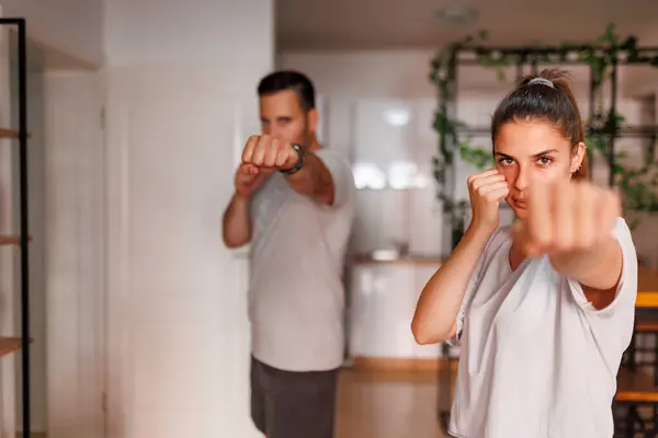 Active Young Couple Exercising Home Together Doing High Punches — Stock Photo, Image