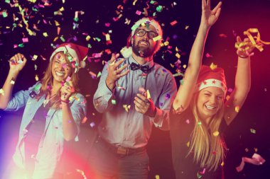 Yeni yıl partisinde dans eden ve eğlenen bir grup genç.