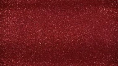 Parlak dokusu, parıldayan ışığı, kıvılcımları ve ışıltısı olan kırmızı ışıltılı arka plan. 