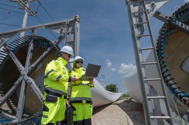 Rüzgâr türbini bakım ve onarım teknisyeni, mühendis türbinleri kontrol ediyor. Rüzgar türbini çiftliğinde bakım ve temiz güç jeneratörü sistemi çalışıyor.