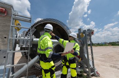 Rüzgâr türbini bakım ve onarım teknisyeni, mühendis türbinleri kontrol ediyor. Rüzgar türbini çiftliğinde bakım ve temiz güç jeneratörü sistemi çalışıyor.