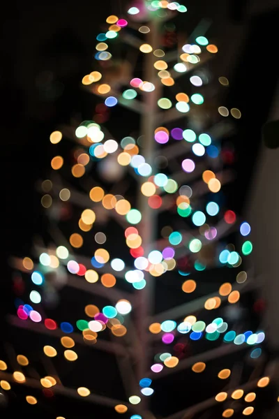 Defokussiertes Bild Eines Beleuchteten Weihnachtsbaums Vor Schwarzem Hintergrund — Stockfoto