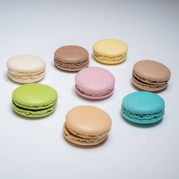 close-up of colorful macaroons on white background