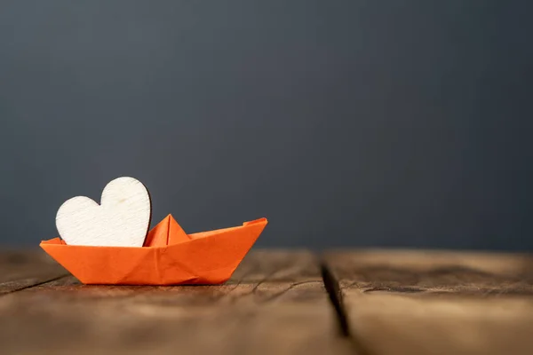 Close Orange Miniature Origami Ship Wooden Heart Wooden Table Dark — Foto Stock