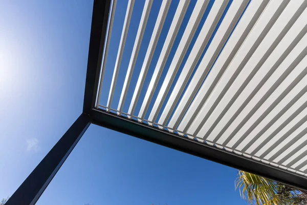 stock image Aluminum pergola for outdoor patio against clear blue sky. Bottom view