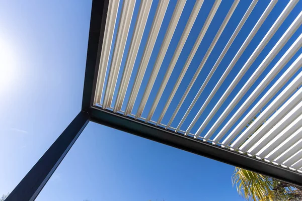 stock image Aluminum pergola for outdoor patio against clear blue sky. Bottom view