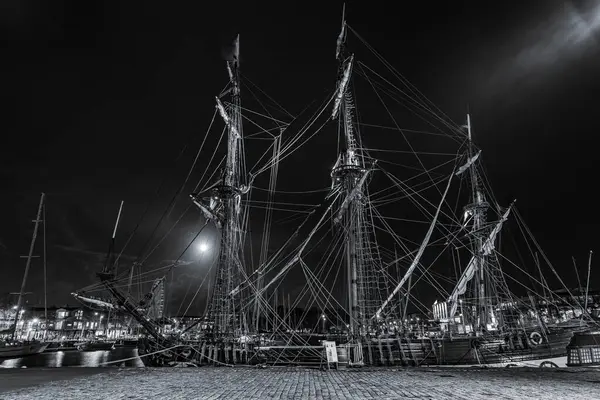 old wooden sail ships moored in the harbor of La Rochelle near the gabut district. night shot in black and white