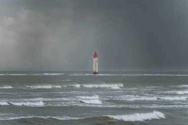 Chauveau lighthouse in the sea during windstorm with waves on a stormy sky clipart