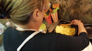 Ev hanımı ev mutfağında geleneksel İspanyol omleti pişiriyor. Yüksek kalite 4k görüntü.