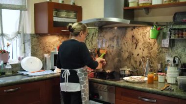 Ev hanımı evde balık güveci pişiriyor. Yüksek kalite 4k görüntü