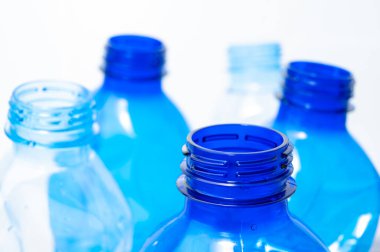 Plastic bottles, blue and transparent, crushed. Waste and plastic pollution, plastic recycling. 