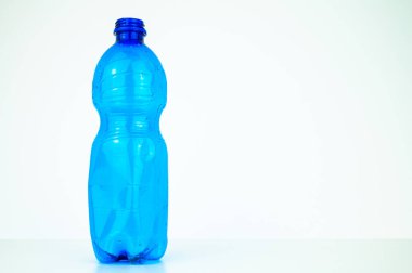 Blue plastic bottle, on a white background. Plastic recycling and eco-sustainability. 