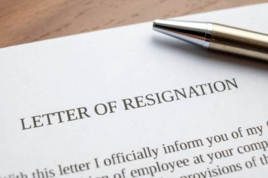 Employee resignation letter and pen beside. 