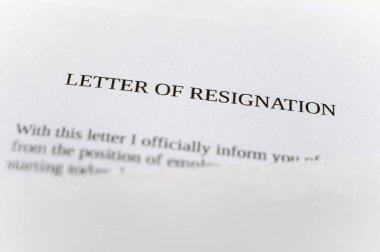 Employee resignation letter and pen beside. 
