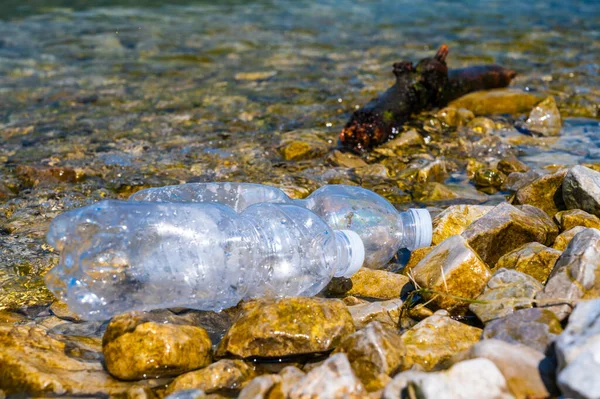 stock image Plastic bottle abandoned in the environment. Plastic pollution and waste recycling.