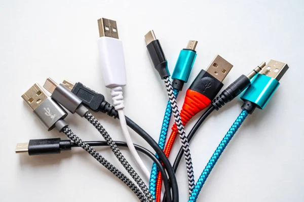 Various types of plugs and cables for audio, video, computer, smartphone and recharging connections. Evolution and change of the types of analog and USB connectors.