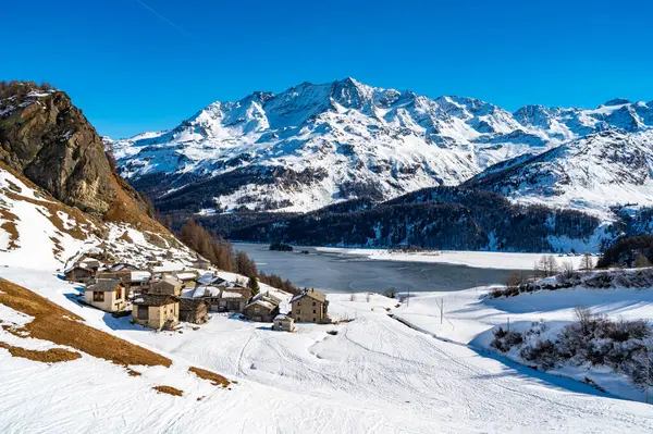 stock image View of the village of Grevasalvas, and Lake Sils, in Engadine, Switzerland, in winter.