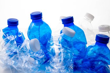 Plastic bottles, blue and transparent, crushed. Waste and plastic pollution, plastic recycling. 