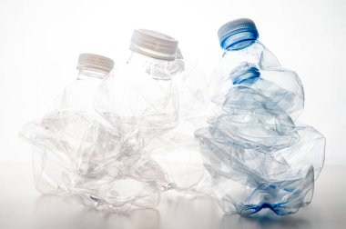 Plastic bottles, blue and transparent, crushed. Waste and plastic pollution, plastic recycling. 