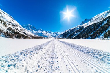 Val Roseg, in Engadine, Switzerland, in winter, with snow-covered cross-country ski slopes. clipart