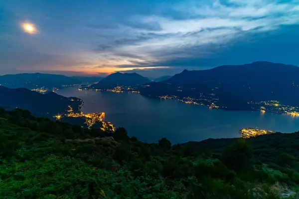 stock image Panorama of Lake Como, with Tremezzina, Villa Balbianello, a glimpse of Lake Lugano, photographed from Alpe Camaggiore, at dusk.