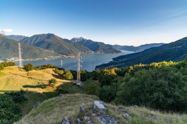 View of Lake Como, towards the south, from Musso, with the overhanging mountains, Dervio, the roads and the towns bordering the lake. clipart