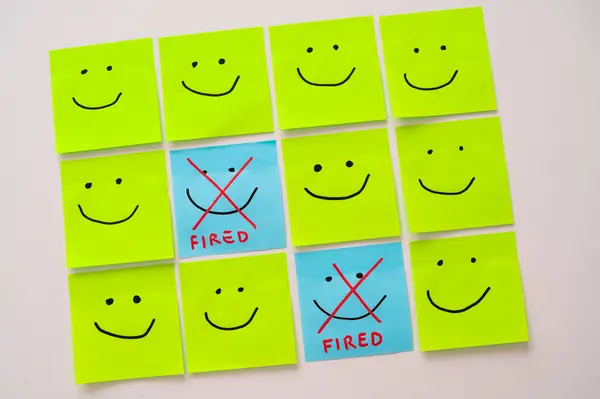 stock image Sheets of paper with smiley faces drawn on them, some with an x drawn on them and the text 