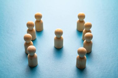 İş yerinde mafya, dışlanma ve psikolojik şiddet kavramı. Ahşap piyonlarla soyut bir tasvir, diğer insanlar tarafından hedef alınan bir kişinin..