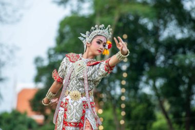 Genç geleneksel Tayland Dansçısı, Tayland 'ın Samut Songkhram kenti Amphawa şehrindeki Loy Krathong Festivali' nde Kasım 2022 'de düzenlenen bir gösteride.