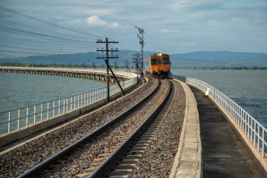 The Train bridge of the Rot Fai Loi Nam Train or floating train line at the Pa Sak Jolasid Dam in near the City of Lopburi in the Province of Lopburi in Thailand,  Thailand, Lopburi, November, 2022