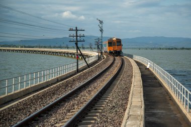 The Train bridge of the Rot Fai Loi Nam Train or floating train line at the Pa Sak Jolasid Dam in near the City of Lopburi in the Province of Lopburi in Thailand,  Thailand, Lopburi, November, 2022 clipart