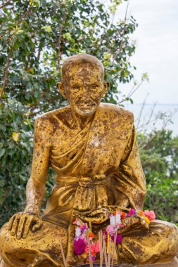 a golden Monk figure at the Khao Thong Chai Mountain in the Town of Ban Krut in the Province of Prachuap Khiri Khan in Thailand,  Thailand, Ban Krut, December, 2022