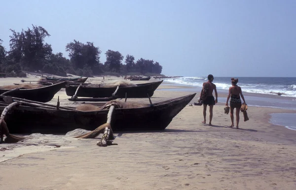 stock image a  wood fishingboat at a sandy Beach with Landscape and Coast at the Town of Vagator in the Province of Goa in India,  India, Goa, April, 1996