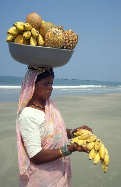 stock image A Indian Women sales Fruits to Tourists at a Beach and Coast at the Town of Vagator in the Province of Goa in India,  India, Goa, April, 1996