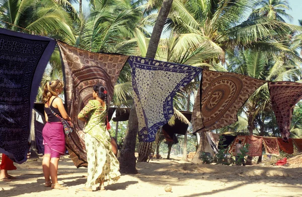 stock image a women sales Batic texties at the Anjuna Flea market on the Coast at the Town of Anjuna in the Province of Goa in India,  India, Goa, April, 1996