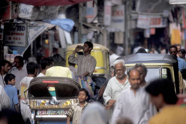 stock image traffic on a marketstreet with a rickshaw Taxi in the old Town of Old Delhi in the city of Delhi in India.  India, Delhi, Februar, 1998