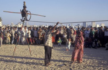 Hindistan 'ın Mumbai şehir merkezindeki Chowpatty Sahili' nde bir soytarı ve sanatçı. Hindistan, Mumbai, Mart 1998