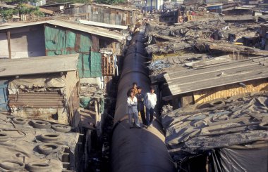 Hindistan 'ın Mumbai şehrinin merkezindeki gecekondu mahallesinde bir su hattı. Hindistan, Mumbai, Mart 1998