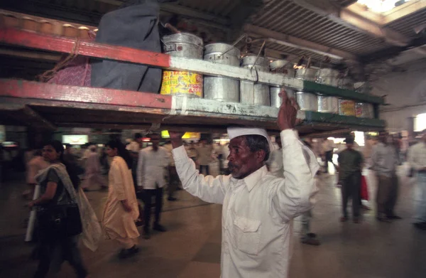 stock image Dabbawalas deliver Lunchboxes to the customers from the Mumbai Railway Station or Chhatrapati Shivaji Terminus in the city centre of Mumbai in India.  India, Mumbai, March, 1998