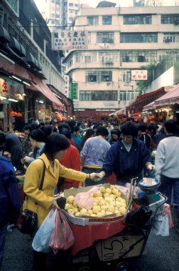 Hong Kong 'daki Kowloon şehrindeki eski bir alışveriş caddesinde yaşayan insanlar. Çin, Hong Kong, Aralık 1997