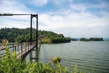 Bridge with landscape at the Lake Kaeng Krachan Dam in the Kaeng Krachan National Park in the Province of Phetchaburi in Thailand at November 19, 2023 clipart