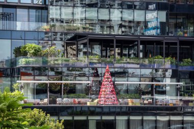 a christmas tree at a Building in Silom in the city of Bangkok in Thailand.  Thailand, Bangkok, December, 4, 2023 clipart
